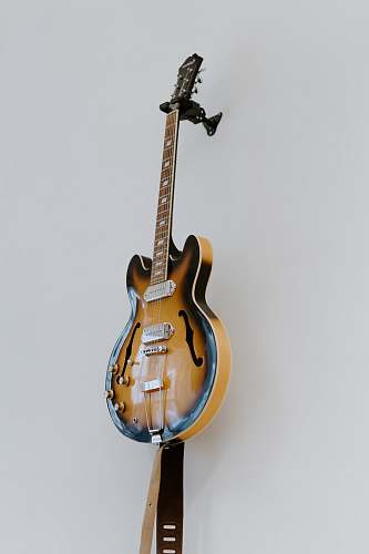 guitar brown electric guitar beside white wall leisure activities